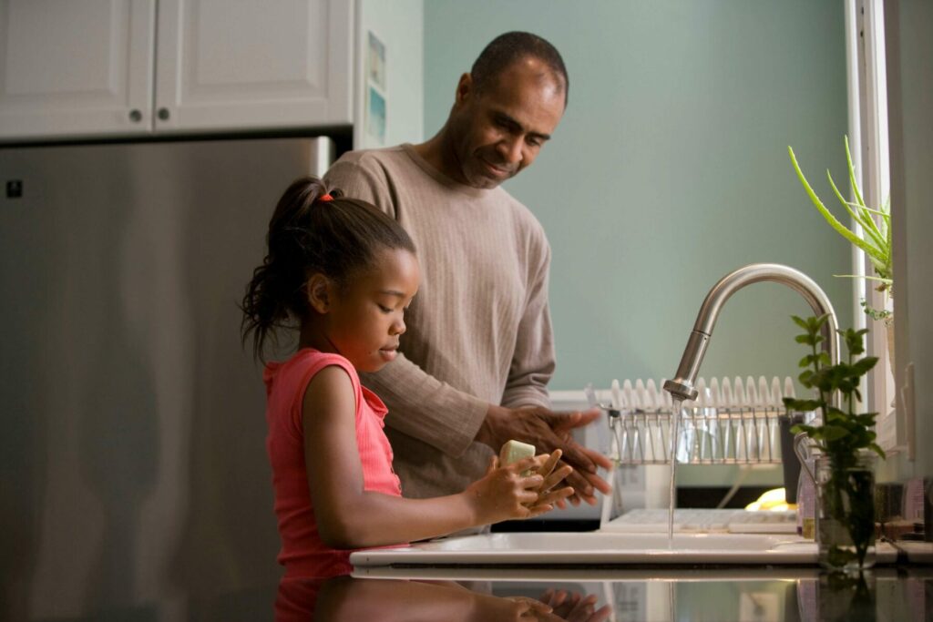 Father teaching her daughter how to wash hands | How ABA Therapy Can Help