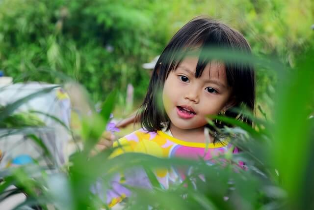 A child staring at a plant | Types of Echolalia