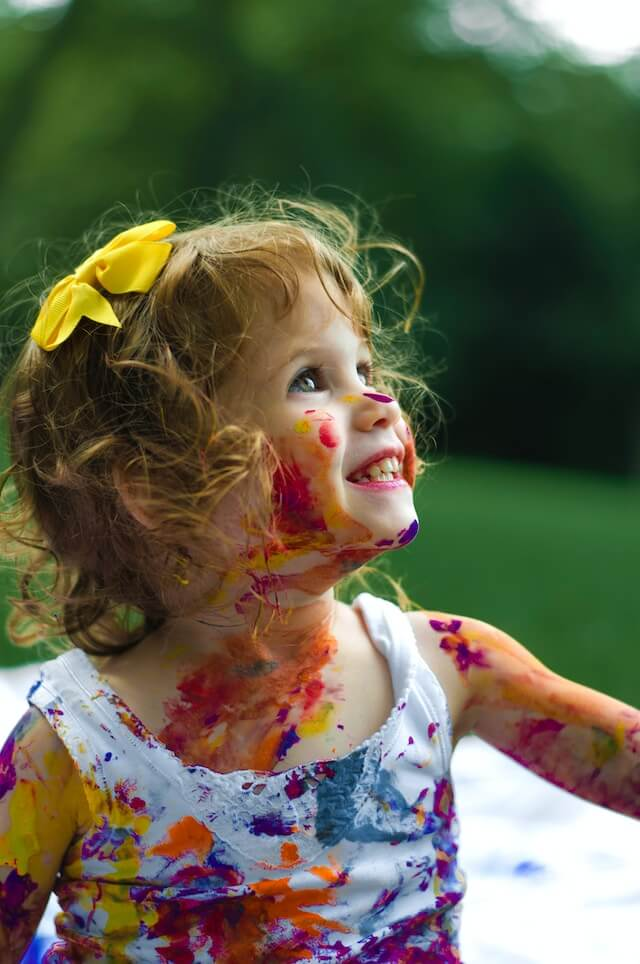 A child covered in paint | Understanding Autism in Girls