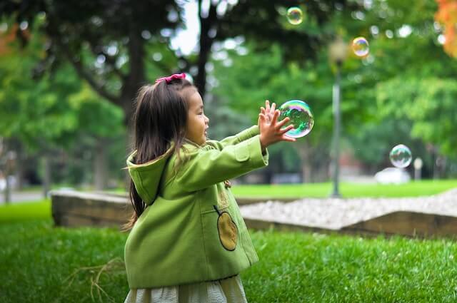 Girl playing with bubbles | Functional Communication and Autistic Children