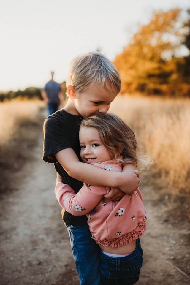 Siblings hugging each other | The Importance of Including Siblings in ABA Therapy