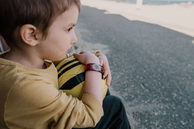 A kid wearing autism bracelet